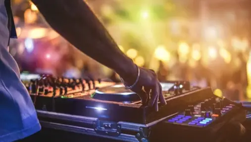 DJ performing at an outdoor event, showcasing liability insurance for entertainers and gig-based performers.